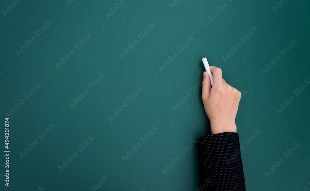 Businesswoman hand writing chalk on blackboard Businesswoman hand writing chalk on blackboard