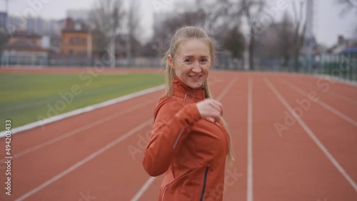 Portrait of woman in sportswear doing jogging at the stadium