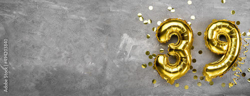 Yellow foil balloon number, number thirty on concrete background. Greeting card with the inscription 39. Anniversary concept. for anniversary, birthday, new year celebration. banner, photo