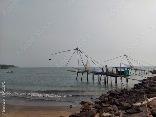 Chinese fishing net in munambam beach Kerala india and moody sky