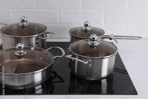 Set of new clean cookware on cooktop in kitchen