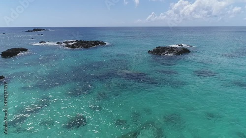 Flyover Submerged rocks on Crystal clear sea, Pacific Ocean. Hawaii