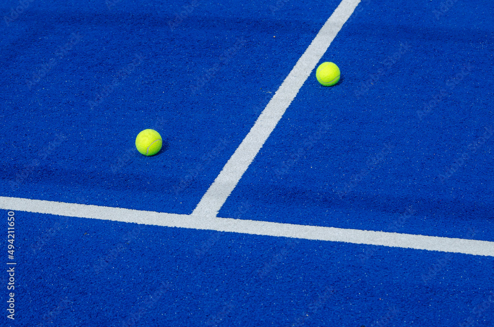two paddle tennis balls on the sides of the center line