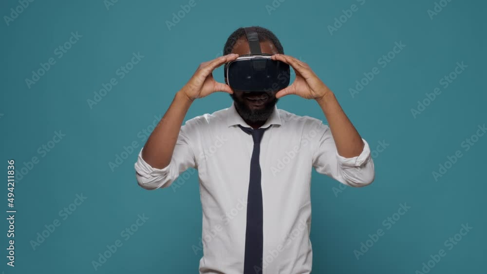 Male freelancer using vr glasses with futuristic vision in studio, working on innovative simulator. Young adult enjoying virtual reality goggles with 3d visual simulation, electronic headset. Male freelancer using vr glasses with futuristic vision in studio, working on innovative simulator. Young adult enjoying virtual reality goggles with 3d visual simulation, electronic headset.