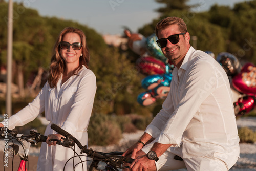 Senior couple enjoying a beautiful morning together riding a bike by the sea. Selective focus © .shock