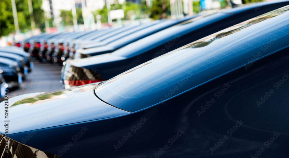 Group of black cars parked in a row Group of black cars parked in a row