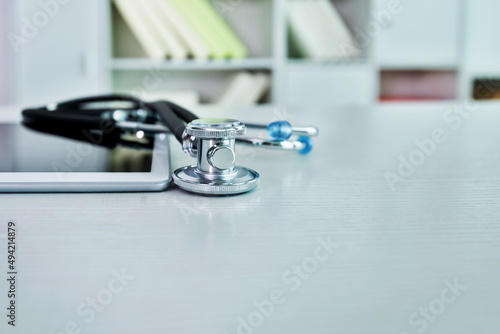 Stethoscope and digital tablet on doctor desk