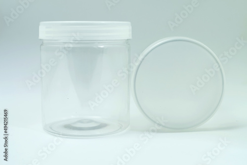 Empty transparent plastic jar with white background