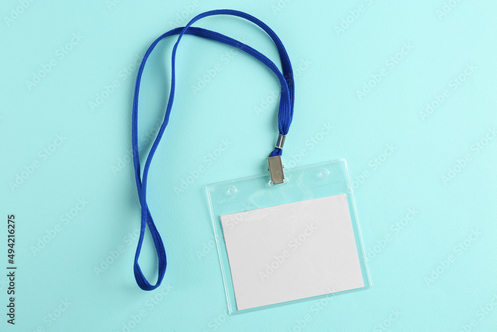 Blank badge on turquoise background, top view. Mockup for design Blank badge on turquoise background, top view. Mockup for design