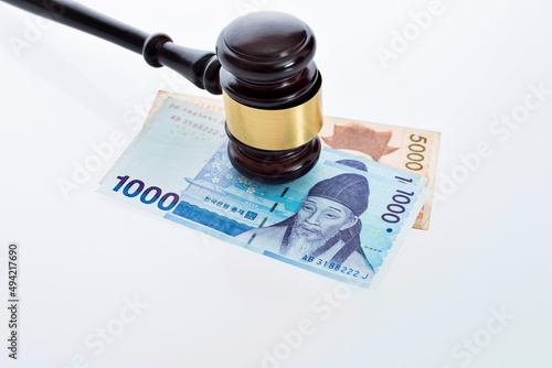 Law gavel on south korea money against white background photo