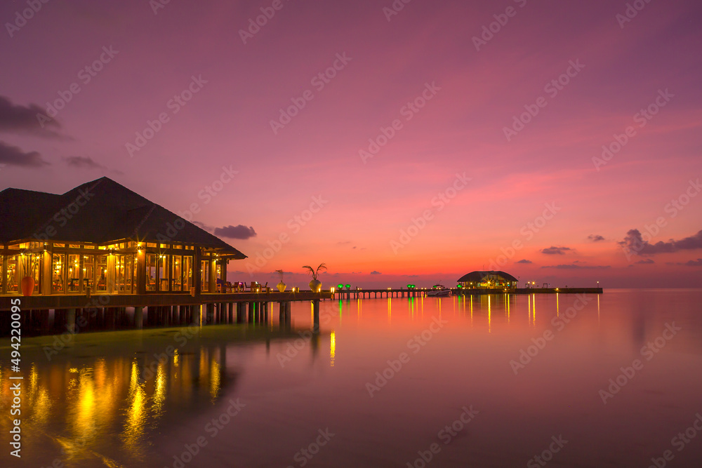 Beautiful sunset in the Maldives with colourful reflections