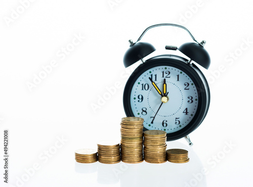 Clock and coins isolated on white background