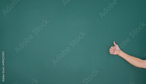 Man hand giving thumbs up on blackboard