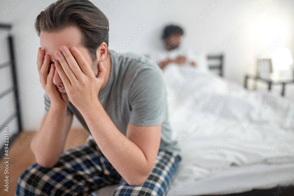 Dark-haired Caucasian man suffering from the break-up Dark-haired Caucasian man suffering from the break-up