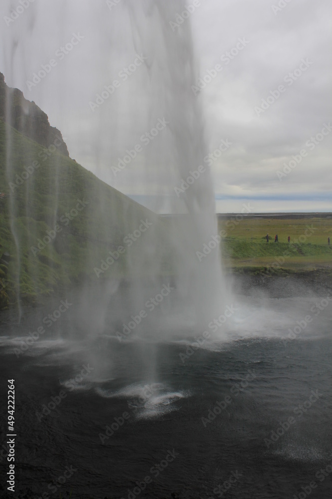 World famous Icelandic Seljalandsfoss waterfall with its characteristic veil (vertical), Seljalandsfoss, Iceland World famous Icelandic Seljalandsfoss waterfall with its characteristic veil (vertical), Seljalandsfoss, Iceland