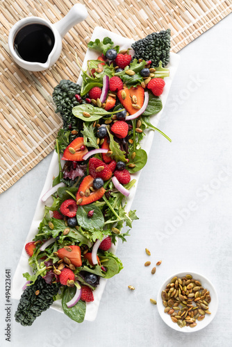 Summer berry salad served with balsamic dressing and toasted pumpkin seeds.