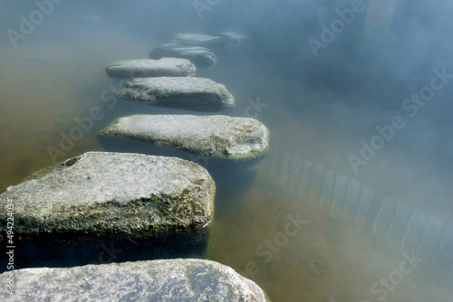 Stepping stones path over a pond photo