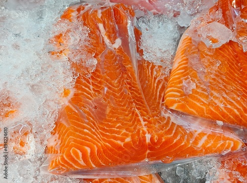 Frozen salmon fillet in plastic packing for sell.