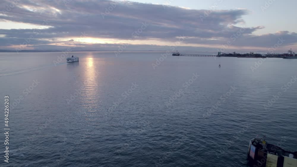 Aerial reverse view of ferryboat cruising toward sunset, Tsawwassen Vancouver terminal in British Columbia, Canada Aerial reverse view of ferryboat cruising toward sunset, Tsawwassen Vancouver terminal in British Columbia, Canada