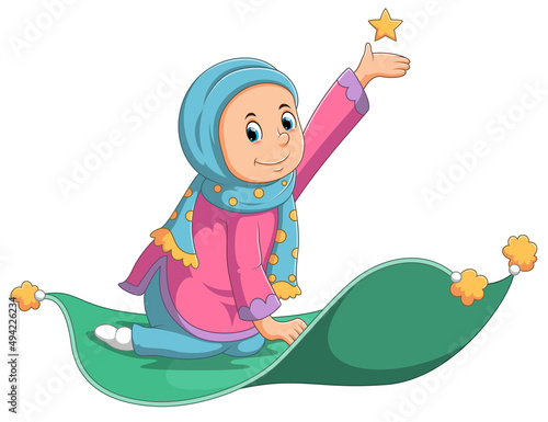 The little girl is sitting on the rug and catching the star