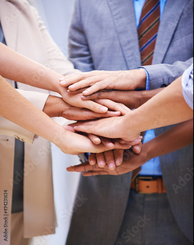 Not I, but we. Cropped shot of a group of coworkers with their hands in a huddle. photo