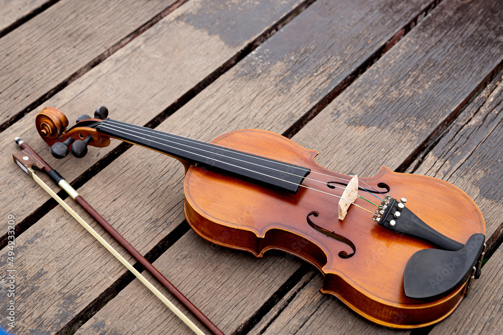 Violin and viola put on wooden floor,During the practice break time to prepare For the concert. Violin and viola put on wooden floor,During the practice break time to prepare For the concert.