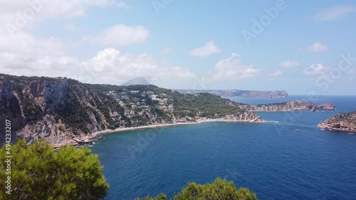 Mirador Cap Negre Viewpoint at Javea, Alicante, Spain - Aerial Drone View (Reveal) of the Coastline with Blue Sea, White Beach and Islands photo