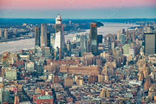 Aerial view of Manhattan West Side skyline along Hudson River at sunset. Hudson Yards on the background.