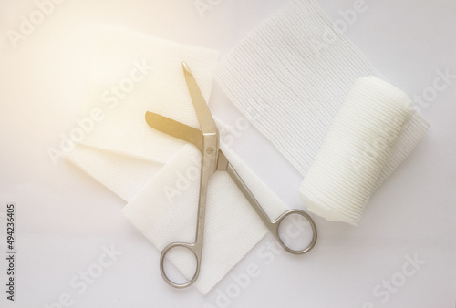 Gauzes, scissors and roll gauze on white background,closed up