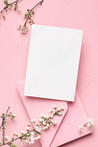 Blank invitation card mockup with envelope and flowers © nikavera