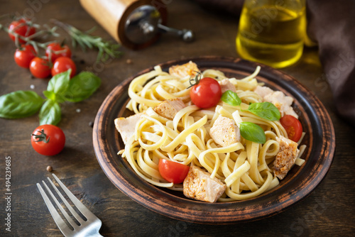 Mediterranean cuisine, seafood diet. Italian spaghetti pasta savory salmon with bechamel sauce on a rustic tabletop.