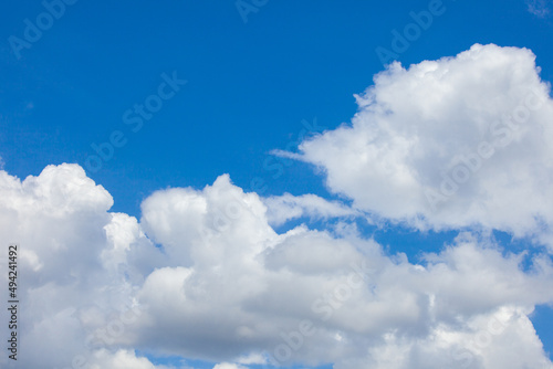 Natural daylight and white clouds floating on blue sky. Concept of freedom and relaxation.