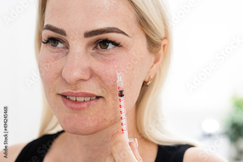 Mesotherapy in the neck and chest-neckline. Traces of hyaluronic acid injections. Light background