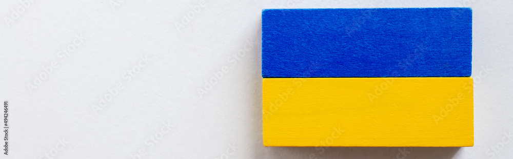 top view of tetragonal blue and yellow blocks on white background, ukrainian concept, banner. top view of tetragonal blue and yellow blocks on white background, ukrainian concept, banner.