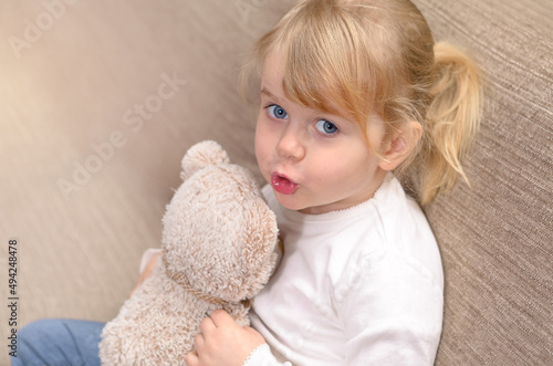 child with teddy bear photo