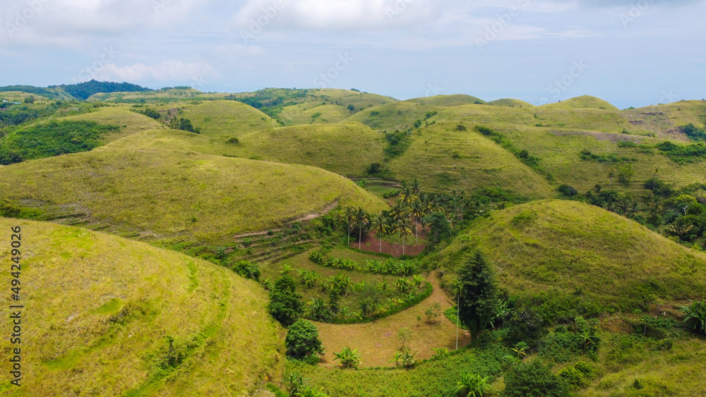 Aerial view of tropical savanna Hill at Nusa Penida , Bali Indonesia. Drone shot scenery of valley / hills at Nusa Penida Bali