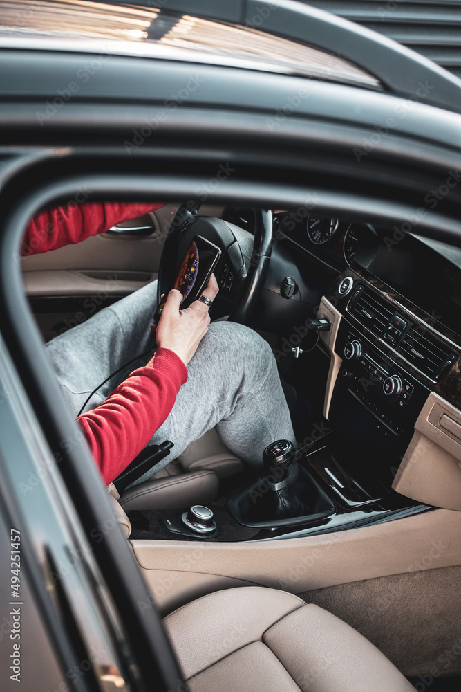 Young boy using his phone in the car Young boy using his phone in the car