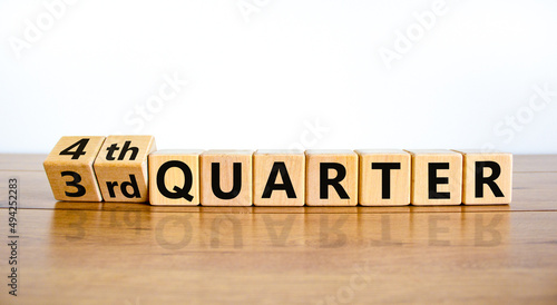 From 3rd third to 4th forth quarter symbol. Turned wooden cubes and changed words 3rd quarter to 4th quarter. Beautiful wooden table white background. Business happy 4th quarter concept. Copy space. photo