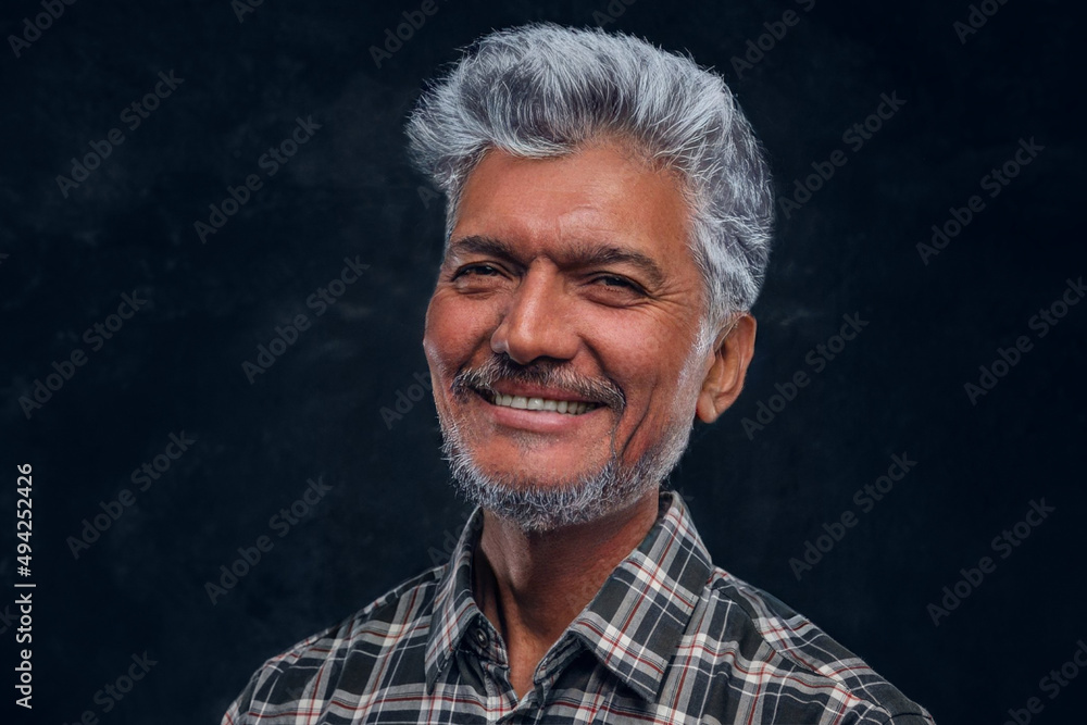 Portrait of glad old man dressed in plaid shirt Portrait of glad old man dressed in plaid shirt