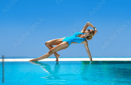 Sexy woman in bikini in the pool at Maldives tropical island. Glamor model in elegant swimsuit in the pool. Perfect body bikini model. Exotic tour. Luxury travel. Travel, tourism. Bikini fashion.