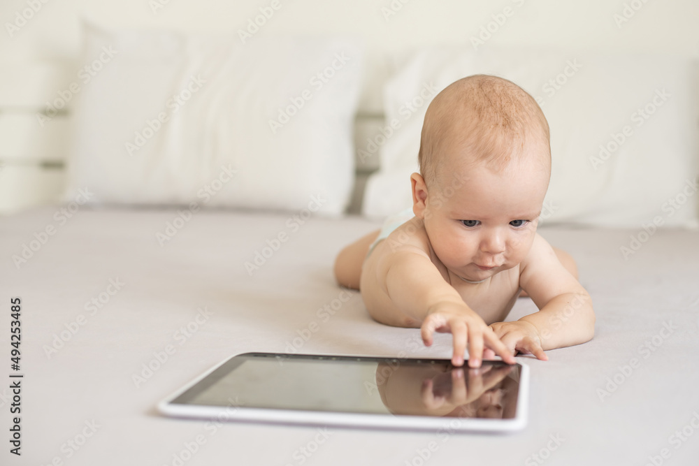Baby girl playing with tablet