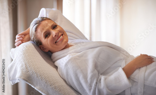 Rejuventated at the wellness center. Cropped shot of a woman in a day spa relaxing on a massage table. photo