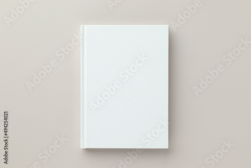 White book blank cover mockup on a beige background, flat lay, mockup