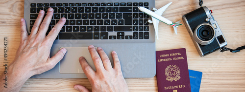 Billede på lærred Horizontal banner or header with male hands typing on modern laptop for booking