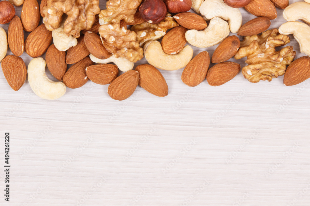 Various nuts and almonds containing healthy natural vitamins and minerals, place for text Various nuts and almonds containing healthy natural vitamins and minerals, place for text