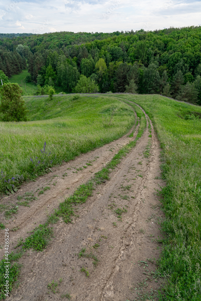 Dirt road runs through rugged countryside