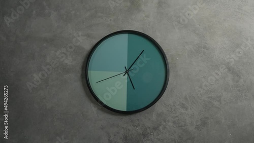 Minimal clock going around on grey background. Time concept.