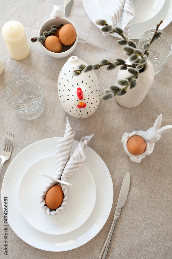 Easter table setting with Easter eggs and willow in vase. Top view. Easter table setting with Easter eggs and willow in vase. Top view.