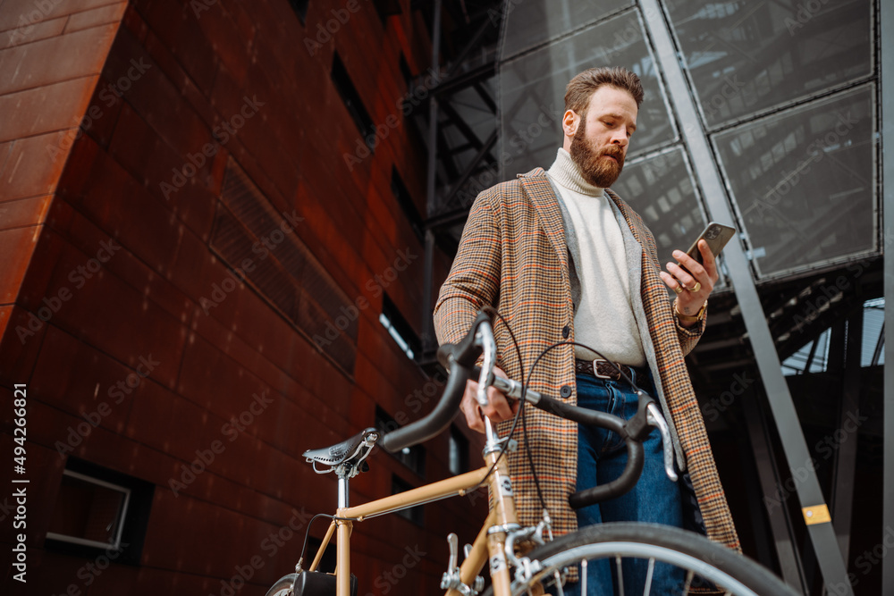 Young man using smartphone with mobile app. Creative businessman in a modern business area. Young man using smartphone with mobile app. Creative businessman in a modern business area.