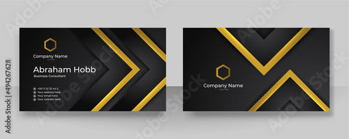 Modern creative and clean business card template. Luxury business card design template. Elegant dark black background with abstract golden shiny wavy lines. Vector illustration
